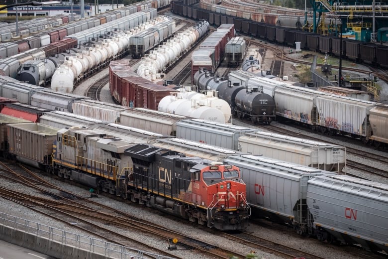 CPKC locomotives on tracks at a rail yard in North Vancouver.