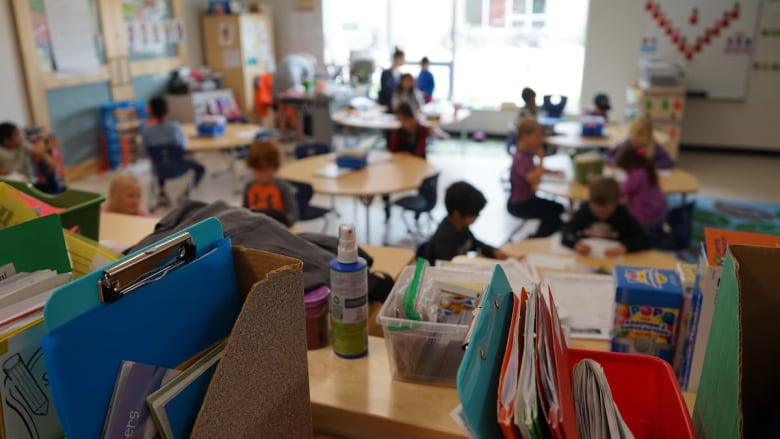 children sitting at tables in a classroom