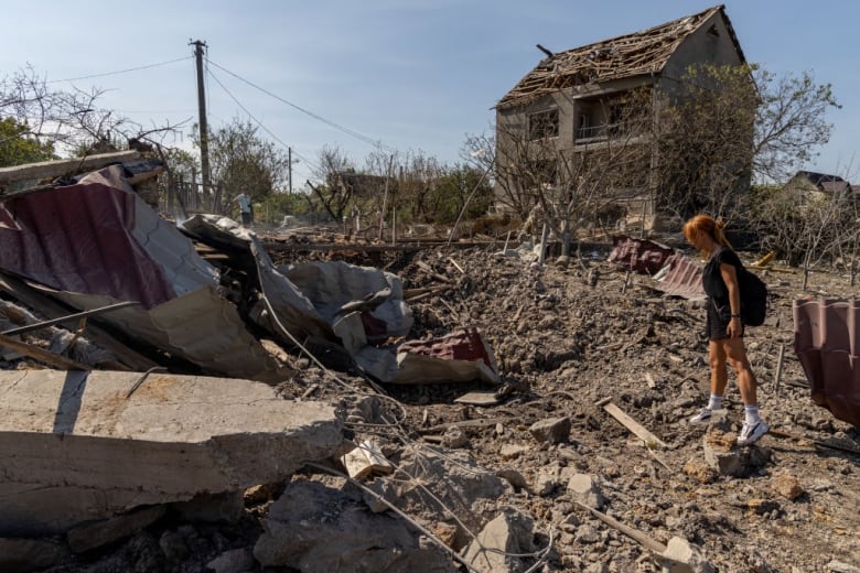 A woman looks at the site of a crater caused by an air attack on Ukraine's Odesa region on Monday.