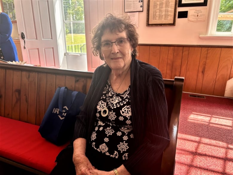 Margaret Power sitting in a pew in St. James United Church.