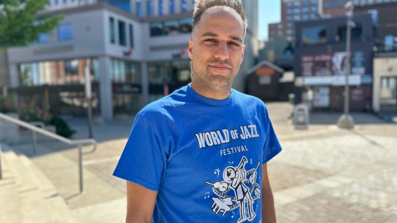 Man standing in a blue t-shirt