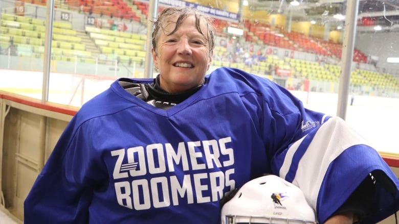 A woman in hockey equipment