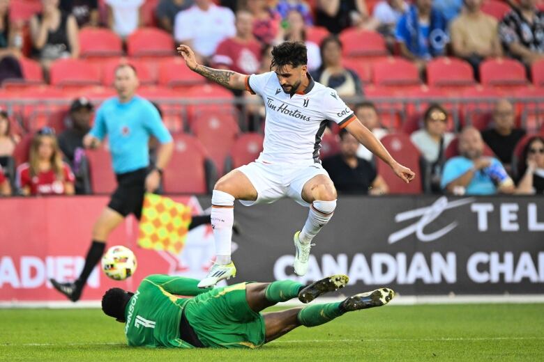 Toronto FC goalkeeper Sean Johnson (1) makes a save against Forge FC forward Tristan Borges (19).