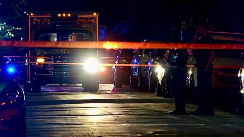 Police cars with tape in dark.