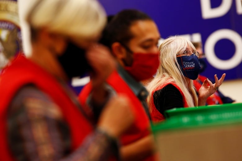 People in masks and red uniforms