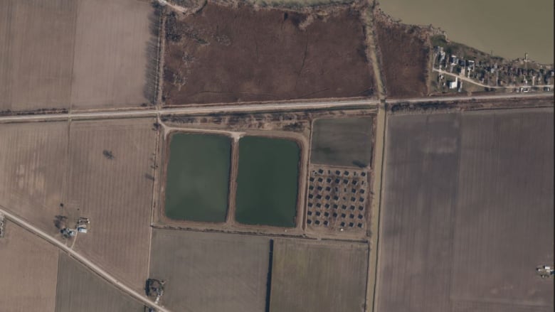 An areal shot of some large lagoons surrounded by fields.