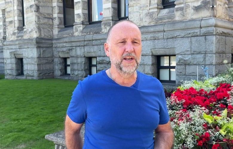 A man in a t-shirt outside.