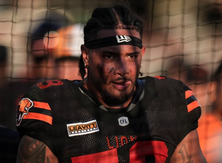 A close up of a man in football attire.