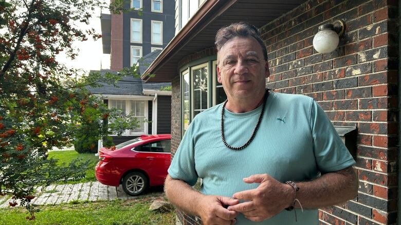 A man standing in front of a house