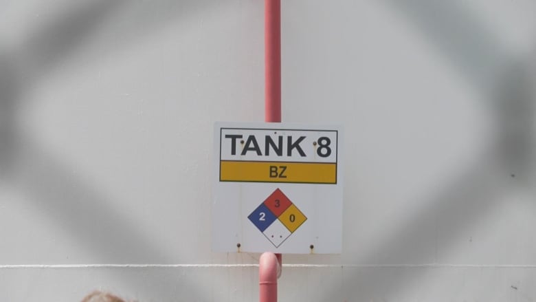 A storage tank that contains benzene sits beside a fence in Sarnia. 