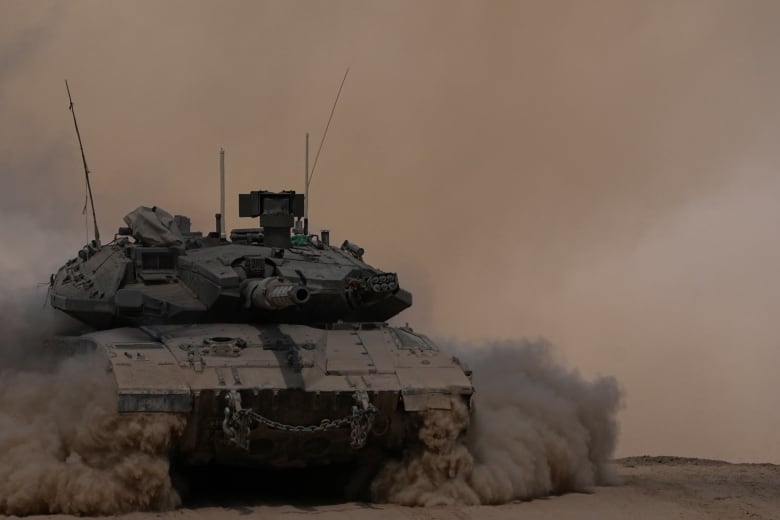 A tank drives through the desert