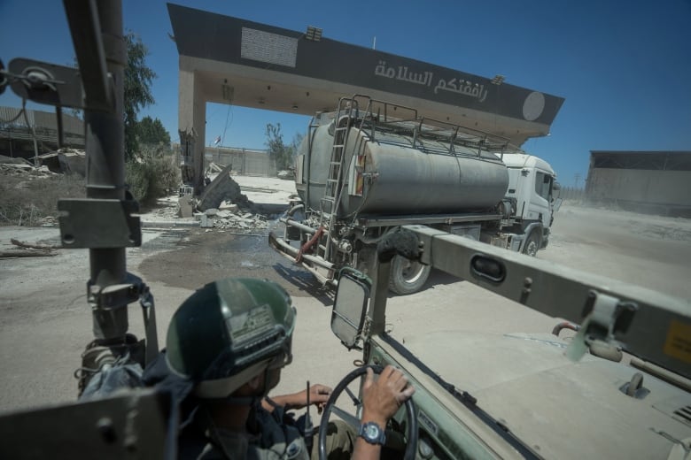 Israeli soldiers drive on the Palestinian side of Kerem Shalom crossing during a ground operation in the Gaza Strip, amid the Israel-Hamas conflict, July 3, 2024.