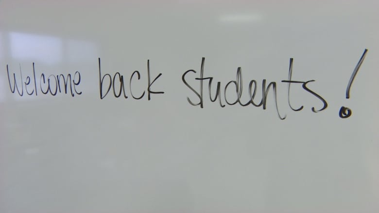 A sign on a board says 'Welcome Back students!