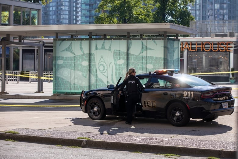 A VPD officer stepping into a police car 