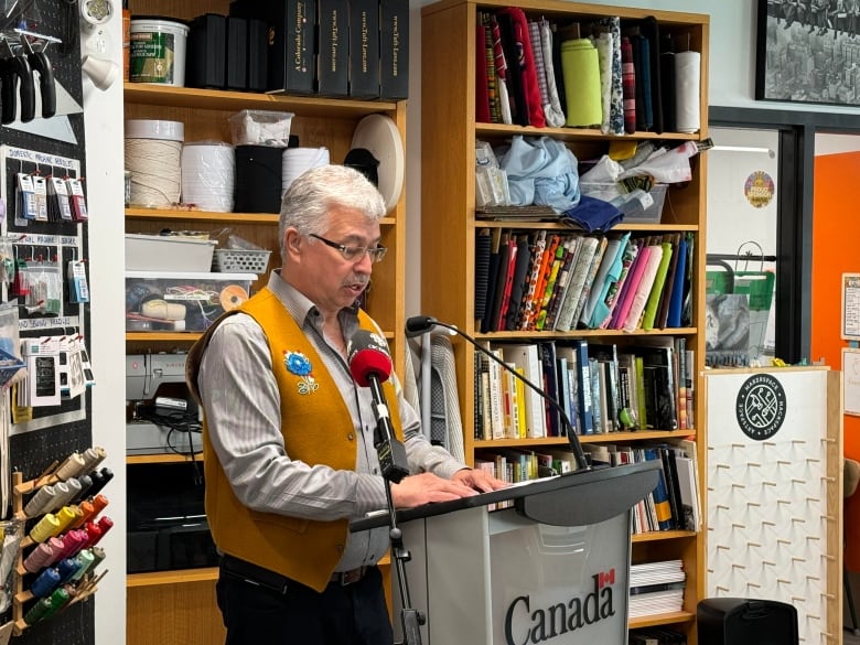 Person talking on a mic podium.