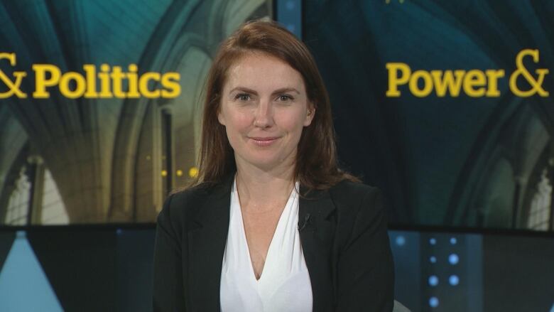 brown haired woman smiling at camera