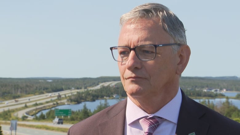 a portrait style photo of union leader Jerry Earle, with highways in the background.