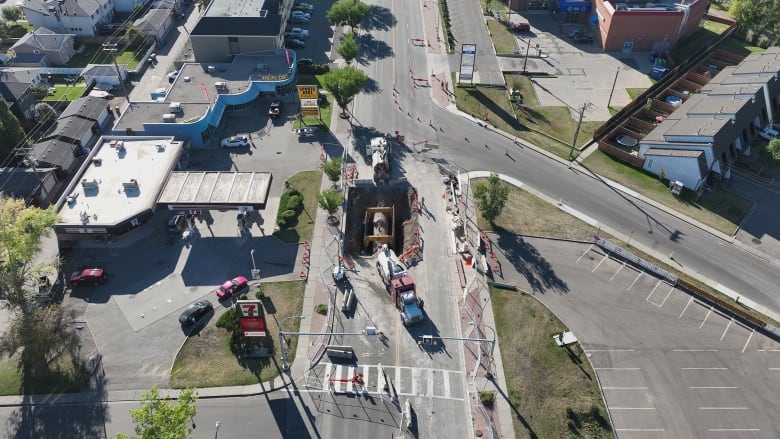 An aerial view of repair work being done on an exposed section of water pipe.