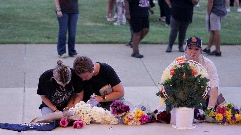 People attend a vigil.