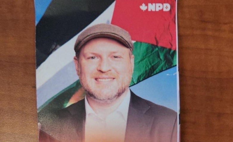 NDP Candidate Craig Sauv's campaign pamphlet depicts him standing in front of a Palestinian flag. 