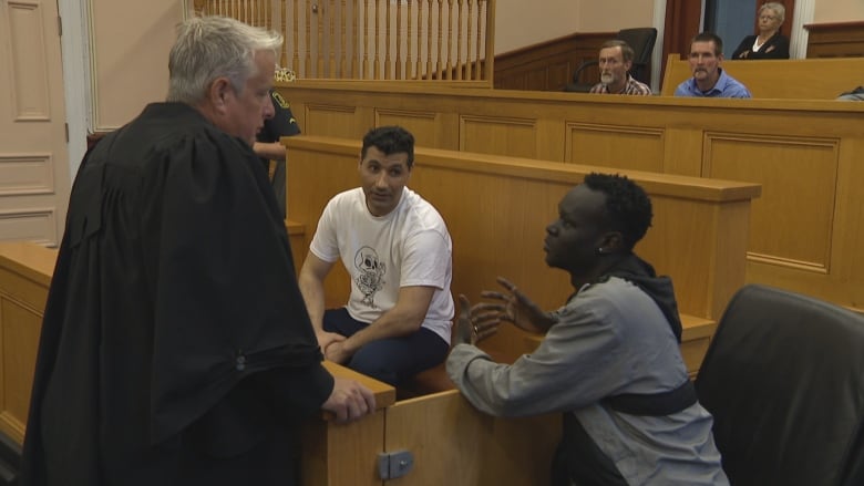 three man in a courtroom