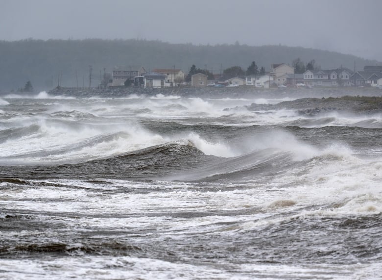 Waves pound the shore in Nova Scotia 2022 during post-tropical storm Fiona, which cause widespread destruction. 