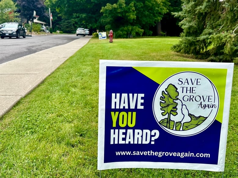 A sign sits on a lawn