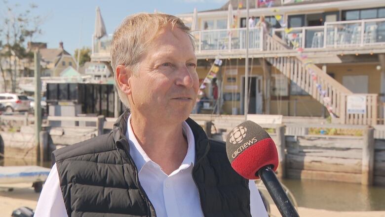 A man stands on a wharf at the Charlottetown Yacht Club.