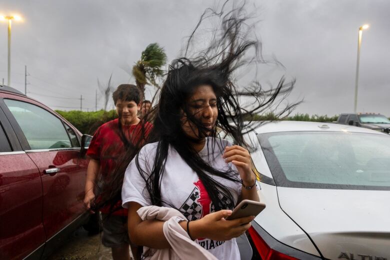 A woman's hair blows in the wind.