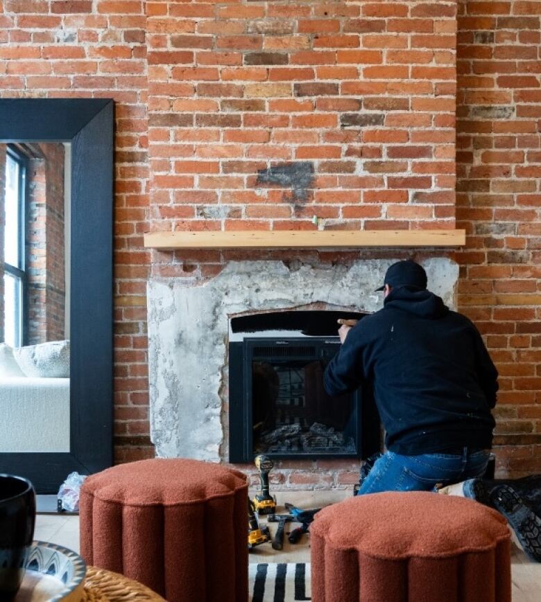 A fireplace is being worked on inside Hotel STRY in Amherstburg, Ont. The boutique lodging destination is set to open in Oct. 2024.