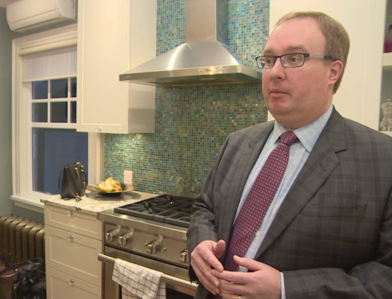 A man standing in a kitchen.