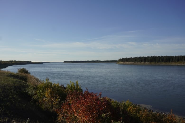 River with fall colours in foliage around the water.