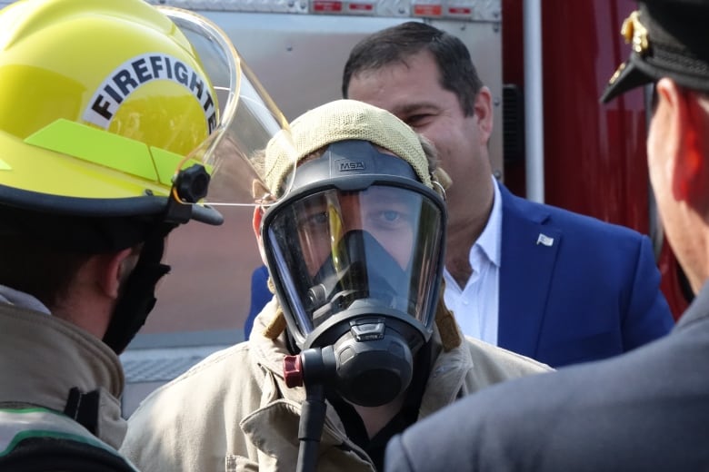 Andrew Furey wears a gas mask and a firefighters uniform.