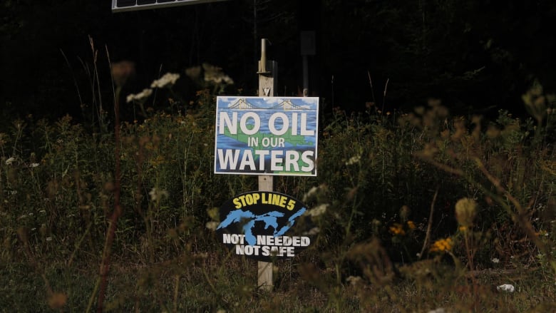 A poster that reads 'No Oil in our Waters', 'Stop Line 5' and 'Not Needed, Not Safe'