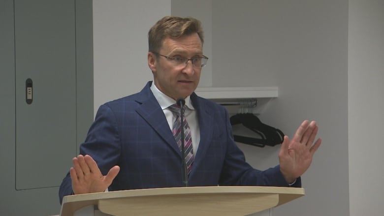 A man stands at a podium. 