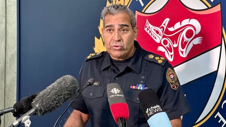 A police chief stands at a press podium. 