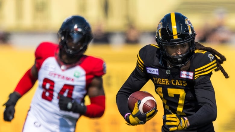 Hamilton Tiger-Cats' Shemar Bridges, right, runs against the Ottawa Redblacks during CFL football action in Hamilton on Saturday, September 14, 2024.