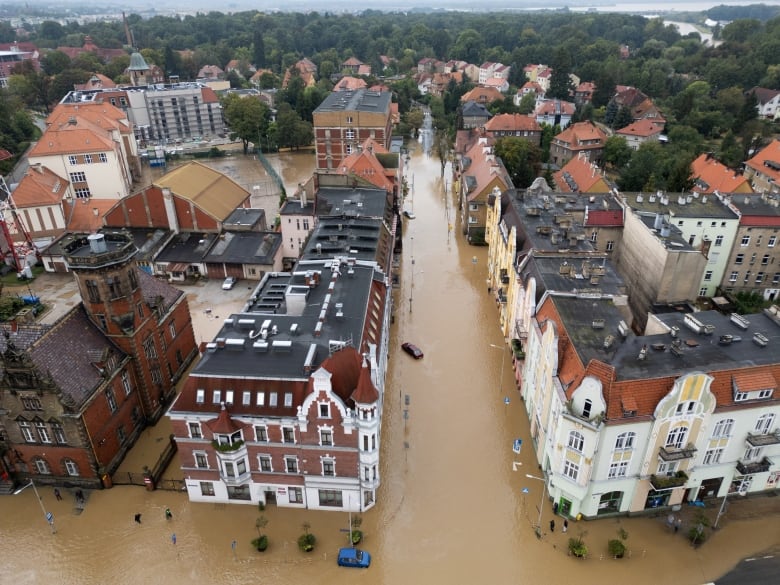 European style architecture shot from high above, the streets covered with brown water.