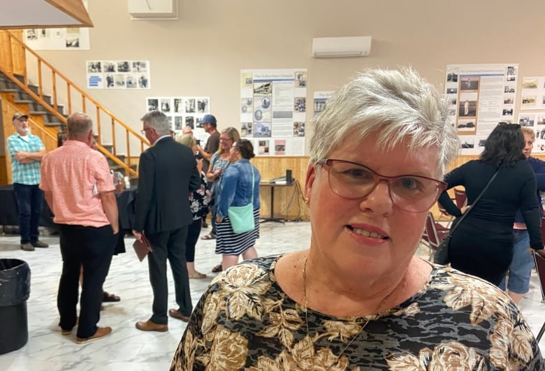 Faith Kennedy stands inside a community hall.