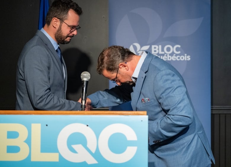 Bloc Qubcois Leader Yves-Francois Blanchet bows as he presents newly-elected candidate Louis-Philippe Sauv 