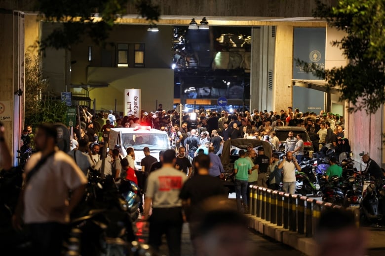 People are seen outside American University of Beirut Medical Center (AUBMC) after more than 1,000 people, including Hezbollah fighters and medics, were wounded when the pagers they use to communicate exploded across Lebanon.