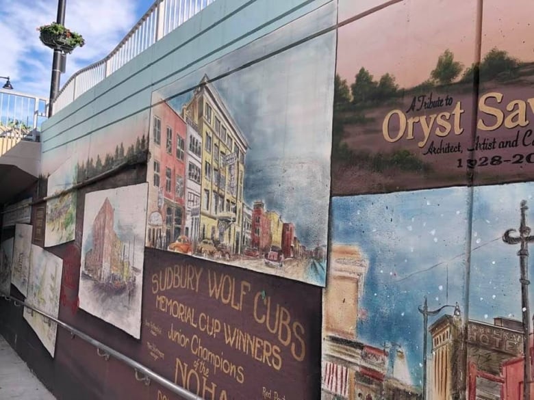 A quaint picture of storefronts memorializng historic places and people in Sudbury