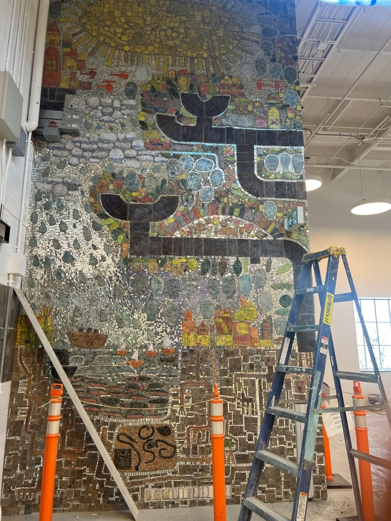 This 20-foot tall mosaic will green visitors in the lobby. 