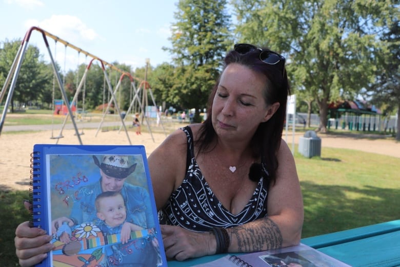 Woman holding up photo album