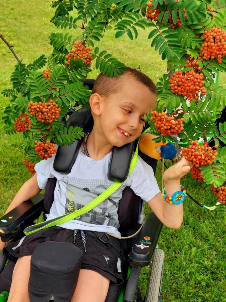 A child in a photo around flowers. 