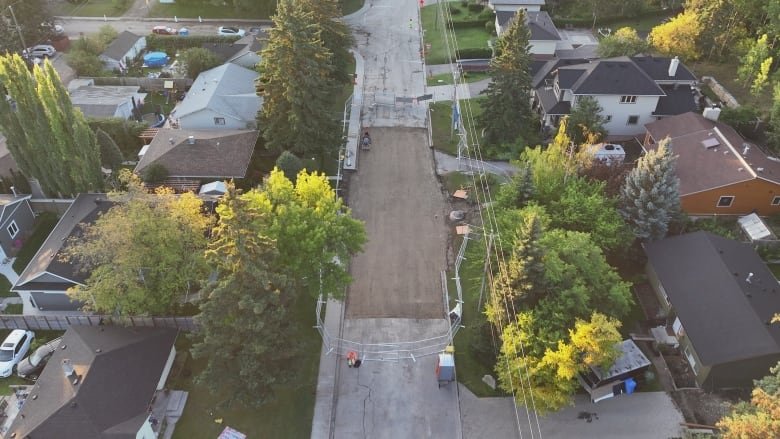 An aerial shot of a water main repair site on the city street.