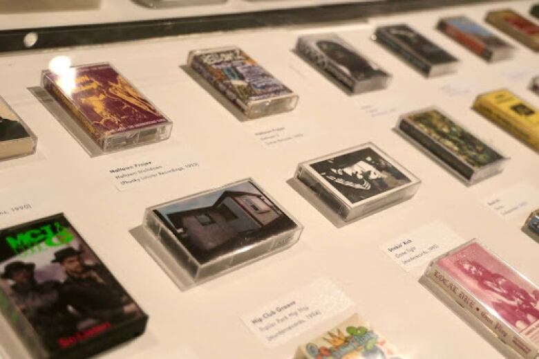 A closeup of a display of hip-hop cassettes.