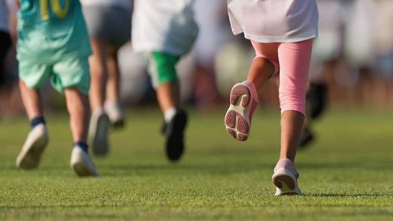 kids legs running on a field