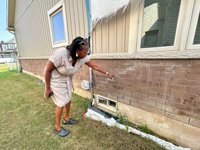 woman points to bricks 