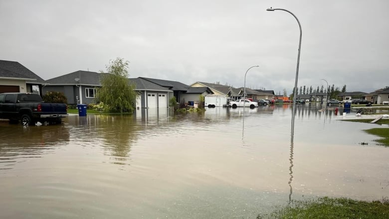 A strip of houses is surrounded by water. 